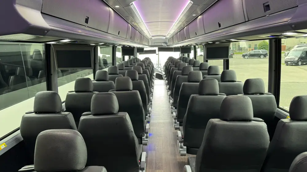 Interior of California Wine Tours motorcoach with wide aisle, reclining seats, and overhead storage for comfort
