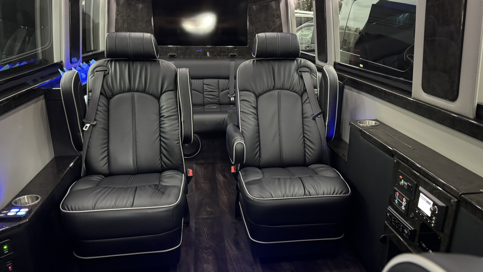 California Wine Tours luxury van with plush captain chairs and entertainment screen for private group wine country trips