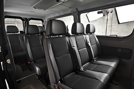 Comfortable shuttle interior with black leather seats in rows, ideal for groups traveling on California Wine Tours.